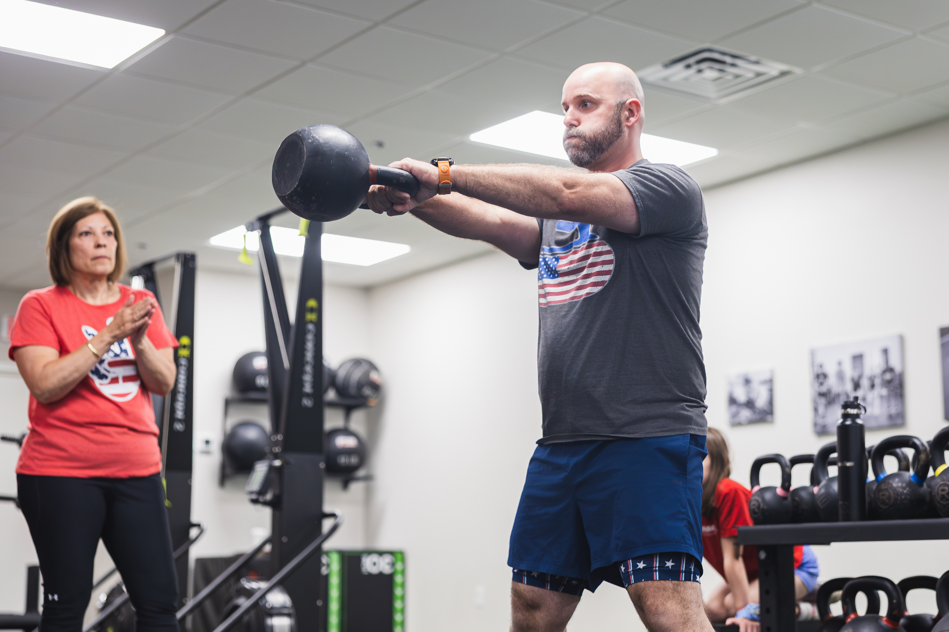 Adult client performing kettlebell swing