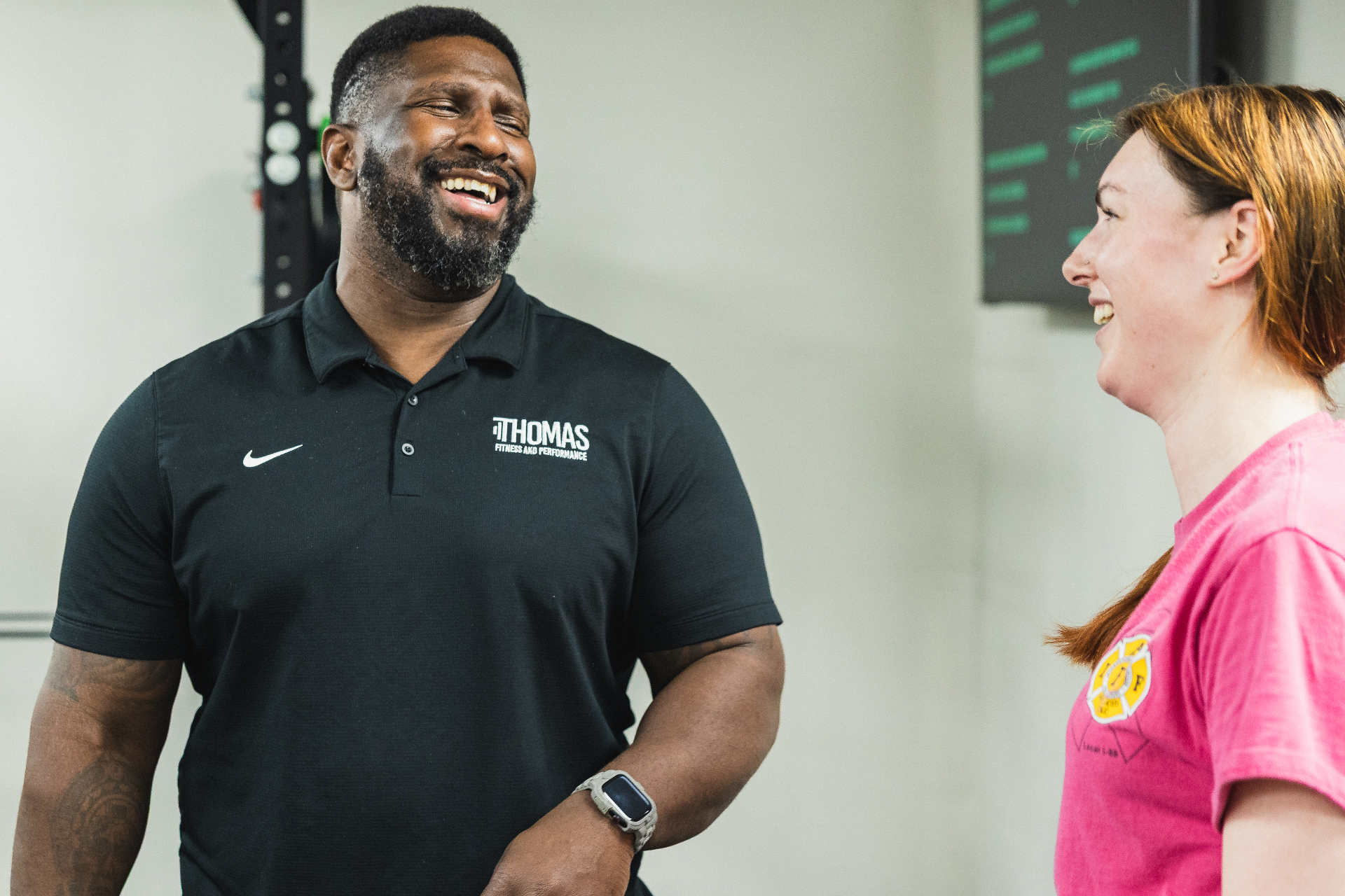 Coach laughing with adult client during a training session