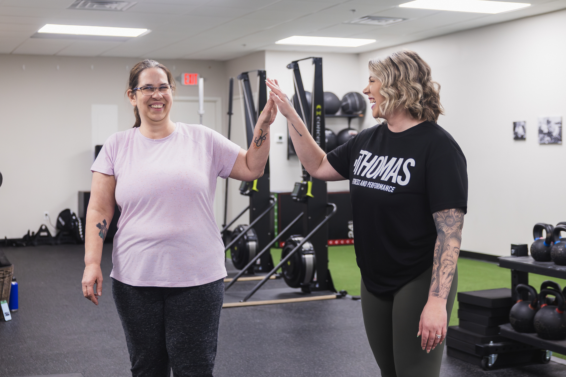 Coach celebrating with adult client after training